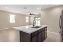Eat-in kitchen featuring a center island with sink, stainless steel appliances and open floor plan at 10974 W Taylor St, Avondale, AZ 85323