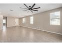 A bright and airy living room with neutral walls, tiled floor, recessed lighting, and ceiling fan at 10974 W Taylor St, Avondale, AZ 85323