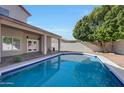 Backyard pool offers a refreshing oasis, complemented by a large shade tree at 11832 E Clinton St, Scottsdale, AZ 85259