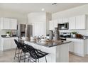Modern kitchen featuring stainless steel appliances and a large island with seating at 1320 W Kennedy Ave, Coolidge, AZ 85128