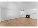 Inviting living room boasts neutral walls, wood floors, and modern ceiling fan at 1658 N Old Colony Dr, Mesa, AZ 85201