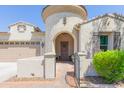 Charming home entrance featuring a circular tower, gated courtyard, and arched doorway at 20084 E Rosa Rd, Queen Creek, AZ 85142