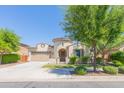 Charming stucco home with a circular tower entrance, mature landscaping, and attached two-car garage at 20084 E Rosa Rd, Queen Creek, AZ 85142