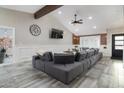 Open living room featuring vaulted ceilings with wood beam, large gray sectional sofa, and stylish decor at 2025 N 87Th Way, Scottsdale, AZ 85257