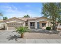 Well-maintained single-Gathering house featuring a two-car garage, desert landscaping, and a welcoming entrance at 21192 E Stirrup St, Queen Creek, AZ 85142
