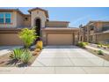 Charming home exterior featuring a desert landscaped yard and a two-car garage with a tile roof at 2425 W Bronco Butte Trl # 2028, Phoenix, AZ 85085