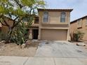 Two-story home with a two car garage, tile roof, and desert landscaping at 2514 W Big Oak St, Phoenix, AZ 85085