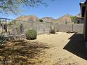 Gravel backyard featuring desert landscaping, block wall and fence with views of the mountains beyond at 2610 W Sat Nam Way, Phoenix, AZ 85086