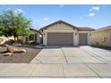 Attractive single story home showcasing neutral toned exterior, tile roof, and three car garage at 27291 W Mohawk Ln, Buckeye, AZ 85396