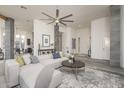 Spacious living room with a large sectional sofa, stylish decor, and modern ceiling fan at 28437 N 112Th Way, Scottsdale, AZ 85262