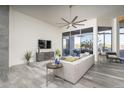 Cozy living room with neutral tones, large windows providing natural light, and comfortable seating at 28437 N 112Th Way, Scottsdale, AZ 85262