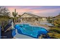 Backyard swimming pool oasis with mature trees, desert landscape and lounge area at 2930 N 154Th Dr, Goodyear, AZ 85395