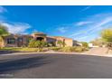 Beautiful home featuring desert landscaping, a circular driveway, and a serene setting at 3042 W Windsong Dr, Phoenix, AZ 85045