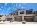 Welcoming townhome featuring beige paint, desert landscaping, and attached garages at 3131 E Legacy Dr # 2055, Phoenix, AZ 85042