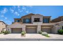Inviting townhome featuring beige paint, desert landscaping and convenient attached garages at 3131 E Legacy Dr # 2055, Phoenix, AZ 85042