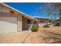 Traditional single-story home with desert landscaping, a two car garage and a brick facade at 3136 W Voltaire Ave, Phoenix, AZ 85029