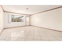Bright and airy living room featuring tile flooring, fresh paint, and natural light at 3136 W Voltaire Ave, Phoenix, AZ 85029