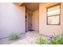 Home entryway with neutral colors, a small window, and desert vegetation at 34457 N Legend Trail Pkwy # 1013, Scottsdale, AZ 85262