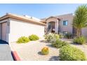 Exterior view with xeriscaping and cactus, and building with stairs and an entryway at 34457 N Legend Trail Pkwy # 1013, Scottsdale, AZ 85262