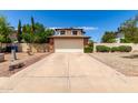 Charming two-story home with a large driveway, low maintenance landscaping, and an attached two car garage at 3730 W Michigan Ave, Glendale, AZ 85308