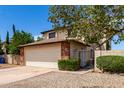 Two story home showcasing a two car garage, brick accents, and well maintained landscaping at 3730 W Michigan Ave, Glendale, AZ 85308