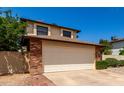 Charming home showcasing a two car garage, brick accents, and well maintained landscaping at 3730 W Michigan Ave, Glendale, AZ 85308