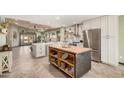 Spacious eat-in kitchen with a center island, stainless steel appliances, and wood flooring at 4377 S Soboba St, Gilbert, AZ 85297