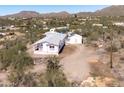 This charming desert home features an exterior and convenient shed at 49039 N 24Th Ave, New River, AZ 85087