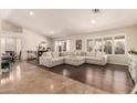 Spacious living room featuring tile and wood floors, neutral paint, recessed lighting and many windows at 4940 S Rosemary Dr, Chandler, AZ 85248