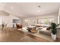 Modern living room design with neutral color palette, stylish furniture, large windows, and tile flooring at 4940 S Rosemary Dr, Chandler, AZ 85248