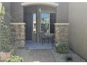 Inviting covered porch with stone accents and outdoor seating at 5637 E Lonesome Trl, Cave Creek, AZ 85331