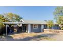 Single-story home featuring a covered carport, privacy fence, and landscaped front yard at 8104 E Jacob Ave, Mesa, AZ 85209