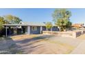 A charming single-story home with a covered carport and a unique front yard at 8104 E Jacob Ave, Mesa, AZ 85209
