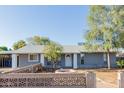 Charming single-story home with a unique front yard and a well-maintained lawn at 8104 E Jacob Ave, Mesa, AZ 85209