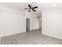 Bright living room with tile flooring, neutral paint, and a ceiling fan for comfortable living at 8339 W Elm St, Phoenix, AZ 85037