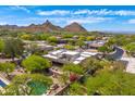 Stunning aerial view of a desert home nestled in a beautiful community with mountain views at 9780 E Gamble Ln, Scottsdale, AZ 85262
