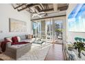 Bright living room featuring exposed ductwork, large windows, and a comfortable gray couch at 1 E Lexington Ave # 302, Phoenix, AZ 85012