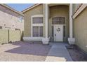 Inviting front entrance with a decorative door, complemented by a low-maintenance, landscaped yard at 1079 E Jasper Dr, Gilbert, AZ 85296