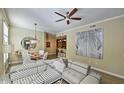 Open-concept living room showcasing modern decor, a dining area, and a breakfast bar, perfect for entertaining at 11640 N Tatum Blvd # 1095, Phoenix, AZ 85028