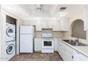 Efficient kitchen layout features white appliances and is conveniently adjoined by a laundry area at 1217 N Miller Rd # 23, Scottsdale, AZ 85257
