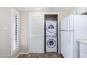 Stackable washer and dryer in laundry area. The space is next to a window, and a full-sized refrigerator at 1217 N Miller Rd # 23, Scottsdale, AZ 85257