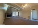 Living room boasts high ceilings, fireplace, neutral paint, and access to a private courtyard at 1217 N Miller Rd # 23, Scottsdale, AZ 85257