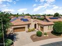 Stunning aerial view of home with desert landscaping, tile roof, and solar panels at 12976 W Plum Rd, Peoria, AZ 85383