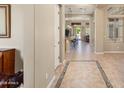 Open foyer featuring tiled flooring, neutral walls, and archways leading to other rooms at 12976 W Plum Rd, Peoria, AZ 85383