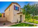 Charming stucco home boasts a tiled roof, manicured lawn, and desert landscaping at 1322 S Owl Dr, Gilbert, AZ 85296