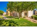 Well-manicured lawn and landscaping add to the curb appeal of this inviting home at 1322 S Owl Dr, Gilbert, AZ 85296