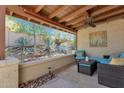Cozy covered patio featuring comfortable seating, ceiling fan, and view of desert plants at 13636 N Hamilton Dr # 101, Fountain Hills, AZ 85268