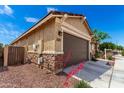 Side view of house with desert landscaping and convenient access to utilities at 14355 W Valentine St, Surprise, AZ 85379