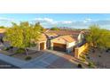 Aerial view of home with a landscaped yard and mountain views at 16229 W Berkeley Rd, Goodyear, AZ 85395