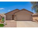 Charming single-story home featuring a neutral color scheme, well-maintained landscaping, and an attached two-car garage at 16274 N 138Th Ln, Surprise, AZ 85374